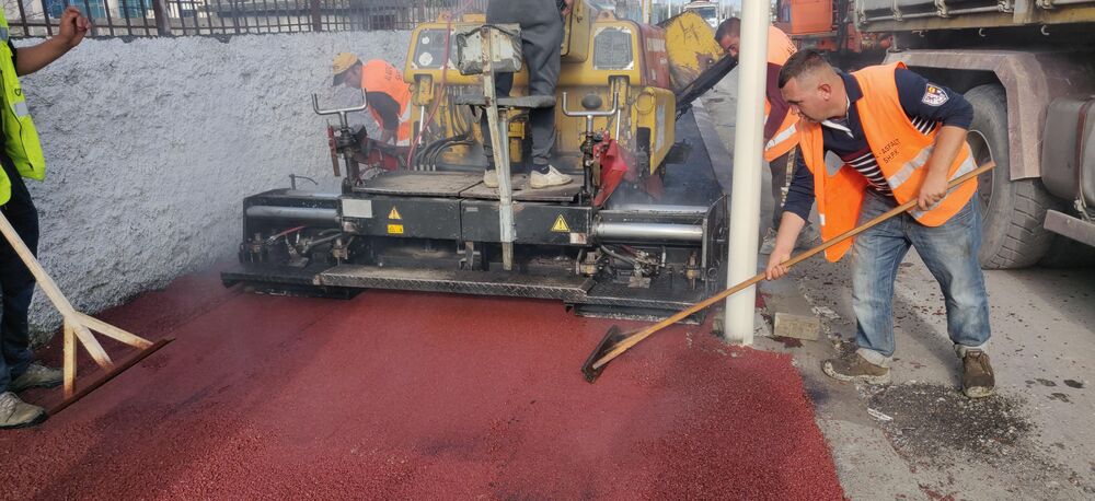 Supply and placement of red modified asphalt in the sidewalk, Shijak Municipality